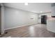 Eat-in kitchen with white cabinets, black appliances, and new flooring at 7659 S Holland Way, Littleton, CO 80128