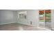 Bright living room offers a sliding glass door to the backyard and new laminate flooring at 7659 S Holland Way, Littleton, CO 80128