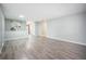 Open living area features new flooring, a half-wall, and ample space for entertaining at 7659 S Holland Way, Littleton, CO 80128