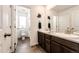 Bright bathroom featuring dual sinks, modern fixtures, and a separate toilet room for added privacy at 985 S Elk Way, Aurora, CO 80018