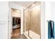 Elegant shower with glass door, tile surround, and adjacent walk-in closet for added convenience at 985 S Elk Way, Aurora, CO 80018