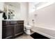 Well-lit bathroom featuring a vanity with a large mirror and a separate toilet and shower area at 985 S Elk Way, Aurora, CO 80018