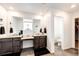 Bright bathroom featuring dual vanities with granite countertops, a separate toilet room, and a walk-in closet at 985 S Elk Way, Aurora, CO 80018