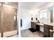 Main bathroom features double sinks, a large vanity, and a glass enclosed shower at 985 S Elk Way, Aurora, CO 80018