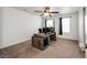 Bedroom featuring a ceiling fan, neutral carpet, and a unique built-in desk area for a workspace at 985 S Elk Way, Aurora, CO 80018
