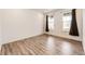 Bright bedroom with wood-look floors and two windows providing natural light at 985 S Elk Way, Aurora, CO 80018