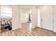 Open entryway leading to a living space and bathroom with modern wood-look flooring at 985 S Elk Way, Aurora, CO 80018