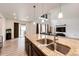 Open-concept kitchen with a large island, granite countertops, and a sink with a view of the living room at 985 S Elk Way, Aurora, CO 80018