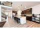 Spacious kitchen features a large center island with granite countertops and dark wood cabinets at 985 S Elk Way, Aurora, CO 80018