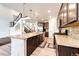 Modern kitchen boasts stainless steel appliances, dark wood cabinets, and a large center island at 985 S Elk Way, Aurora, CO 80018