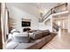 Open-concept living space featuring a spacious seating area, high ceilings, and modern staircase at 985 S Elk Way, Aurora, CO 80018
