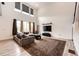 Bright living room with a high ceiling, a large sectional sofa, and stylish decor at 985 S Elk Way, Aurora, CO 80018