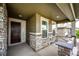 Inviting front porch with stone accents, providing a welcoming entrance to the home at 985 S Elk Way, Aurora, CO 80018