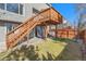 Backyard with a deck and lower patio area surrounded by green grass and a wooden fence at 9230 W Indore Dr, Littleton, CO 80128