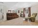 Finished basement with neutral carpet, couch, curtains, and walk out access at 9230 W Indore Dr, Littleton, CO 80128