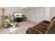 Finished basement with neutral carpet, comfortable reclining chair, and electric fireplace at 9230 W Indore Dr, Littleton, CO 80128
