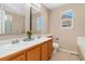 Bathroom with a double vanity and decorative mirrors, offering a functional and stylish space at 9230 W Indore Dr, Littleton, CO 80128