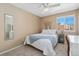 Serene bedroom with a comfortable bed, desk, and window, providing a relaxing and functional space at 9230 W Indore Dr, Littleton, CO 80128