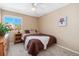 Cozy bedroom with a full-sized bed, dresser, and window with view, creating a comfortable and inviting space at 9230 W Indore Dr, Littleton, CO 80128