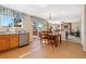 Open concept dining area flows into the living room with sliding glass doors to the patio at 9230 W Indore Dr, Littleton, CO 80128
