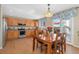 Kitchen area with wood cabinets, stainless appliances, and dining table at 9230 W Indore Dr, Littleton, CO 80128
