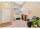 Bright living room boasts high ceilings, large window, and comfortable seating at 9230 W Indore Dr, Littleton, CO 80128