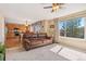 Open concept living room flowing into the kitchen, features a large window and comfortable seating at 9230 W Indore Dr, Littleton, CO 80128