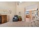 Comfortable living room area with large windows, chair and wine rack at 9230 W Indore Dr, Littleton, CO 80128