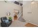Inviting living room featuring staircase, high ceilings, and cozy seating area at 9230 W Indore Dr, Littleton, CO 80128
