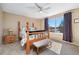 Relaxing bedroom with a four-poster bed, bench, and large window providing ample natural light at 9230 W Indore Dr, Littleton, CO 80128