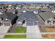 Stunning aerial view of a well-maintained gray home with a three car garage in a Gathering-friendly community at 9035 S Shawnee Ct, Aurora, CO 80016
