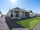 Relaxing backyard featuring a covered patio, gravel landscaping, and lush green lawn space at 9035 S Shawnee Ct, Aurora, CO 80016