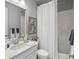 Bathroom with white subway tile, white vanity, and framed artwork at 9035 S Shawnee Ct, Aurora, CO 80016