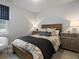 Cozy bedroom with a rustic wood bed frame, decorative pillows, and two matching nightstands at 9035 S Shawnee Ct, Aurora, CO 80016