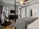 Spacious main bedroom featuring a tray ceiling, dark wood accents, and an ensuite bathroom at 9035 S Shawnee Ct, Aurora, CO 80016