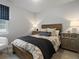 Bedroom with a rustic wood frame bed, neutral bedding and side tables with lamps at 9035 S Shawnee Ct, Aurora, CO 80016