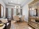 Elegant dining room with a round table, stylish chairs, and decorative mirror cabinet under a tray ceiling at 9035 S Shawnee Ct, Aurora, CO 80016