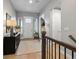 Bright entryway features a white front door, wood floors, console table, and staircase with wood railing at 9035 S Shawnee Ct, Aurora, CO 80016
