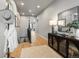 Bright hallway with hardwood floors, a decorative console table with mirror, and hat rack at 9035 S Shawnee Ct, Aurora, CO 80016