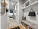 Inviting hallway with a built-in bench, storage baskets, and hooks for organization at 9035 S Shawnee Ct, Aurora, CO 80016