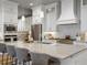 A modern kitchen features stainless steel appliances, sleek countertops, and ample cabinet space with an island at 9035 S Shawnee Ct, Aurora, CO 80016