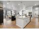 Modern kitchen with stainless steel appliances and center island, open to the living room at 9035 S Shawnee Ct, Aurora, CO 80016