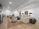 Spacious living room with hardwood floors, neutral furniture, and ample lighting at 9035 S Shawnee Ct, Aurora, CO 80016