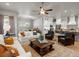 Spacious open-concept living room with ample seating, seamlessly connected to the dining area and modern kitchen at 9035 S Shawnee Ct, Aurora, CO 80016