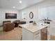 Cozy room featuring leather chairs, hardwood floors, and a wine fridge at 9035 S Shawnee Ct, Aurora, CO 80016