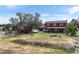 Expansive backyard showing an outdoor seating area, fire pit, and views of the red barn and home exterior at 20155 E Davies Ave, Centennial, CO 80016