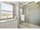 Bathroom featuring white sink, granite counters, a window, tiled shower and a white towel at 20155 E Davies Ave, Centennial, CO 80016