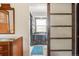 View into the bathroom featuring sliding glass doors, cabinets, blue rug, a mirror and sink at 20155 E Davies Ave, Centennial, CO 80016