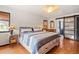 Bedroom featuring a queen bed with a blue and white quilt and an attached closet with a sliding door at 20155 E Davies Ave, Centennial, CO 80016