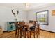 Inviting dining room with hardwood floors, a wooden table with seating for six, and a decorative skull on the wall at 20155 E Davies Ave, Centennial, CO 80016